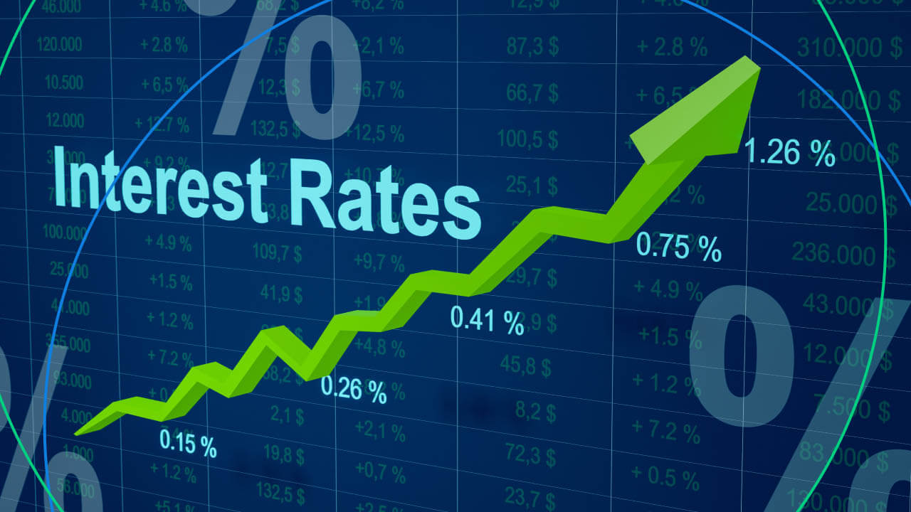 The image shows a rising interest rate trend on a financial chart with the label "Interest Rates" and various percentage increases.