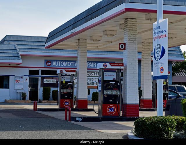 A top-down view of an architect's workspace featuring blueprints, a laptop, a tablet with building plans, a hard hat, and various drafting tools.