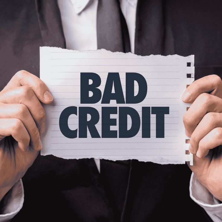 Business owner holding a paper with the words ‘Bad Credit,’ representing poor credit history and challenges in securing traditional business financing.