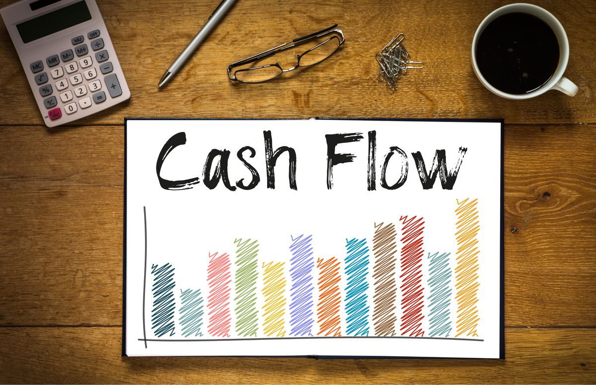 A cash flow chart displayed on a desk with office items, illustrating financial tracking and analysis.