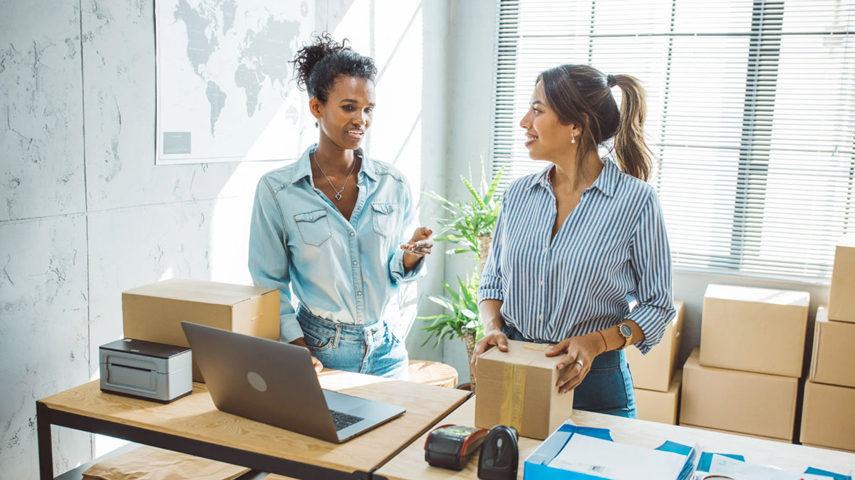 Modern business banking lounge with entrepreneurs using self-service terminals, representing merchant cash advances with no bank statements for fast small business funding.